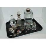 A lot comprising a silver-topped decanter, scent bottles, salts and pepper, silver shoe horn etc
