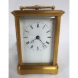A brass cased carriage clock Condition Report: lacking handle for door and no key.