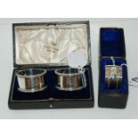 A lot comprising a cased pair of silver napkin rings, Sheffield 1938 and a cased EP napkin ring