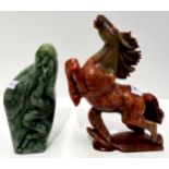 A soapstone carving of a snake and another of a horse Condition Report: Available upon request