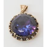 A 14k yellow and white gold faux colour change amethyst pendant, diameter 2.3gms weight 9.4gms