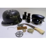 A lot comprising a German helmet, an Iron Cross, a badge, an Argyll's cap badge, ethnic dagger, a