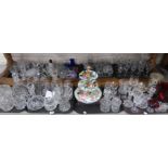 A large selection of cut glass and crystal including decanters, drinking glasses, candlesticks,