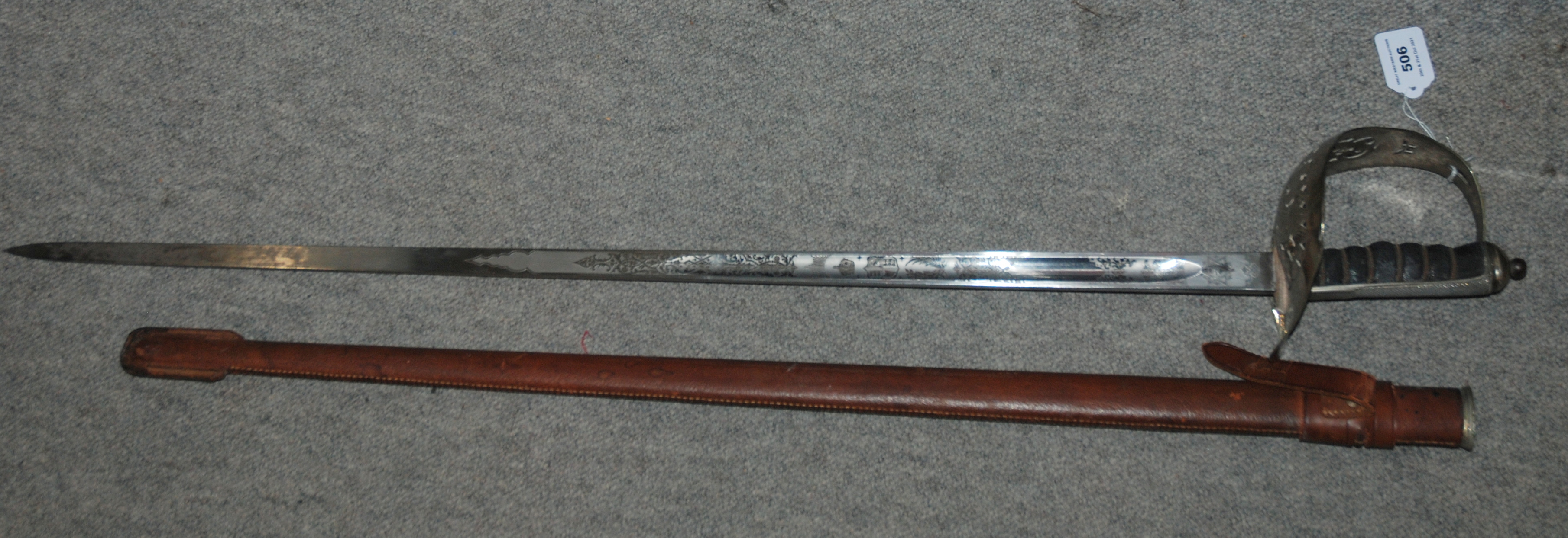 An officers sword with brown leather scabbard, with pierced hand guard and sypher, Fenton Bros,
