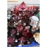 A large selection of cranberry and ruby glass including gilt decorated cups, enamelled ewers,