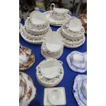 A Wedgwood Strawberry Hill pattern dinner service comprising two oval platters, sauce boat and two
