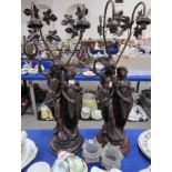 A pair of bronzed resin figural table lamps modelled as classical figures on circular bases, with