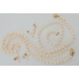 Two strings of pearls with 9ct clasps, a pair of 9ct pearl earrings and two odd examples Condition