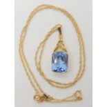 An 18ct gold pendant set with a blue glass gem, weight 3.8gms, on a 9ct gold rope chain length 45cm,