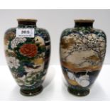 A pair of Satsuma vases decorated with storks and prunus to one side and finches and