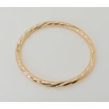 A 9ct gold twist pattern bangle, inner diameter 6.5cm, weight 8.6gms Condition Report: Available