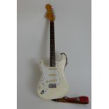 A 1980's left handed Fender Stratocaster serial number E552101 in pearl white with original Fender