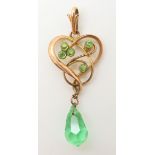 A yellow metal Art Nouveau pendant set with green gems and a later glass drop, length 5.4cm,
