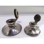 A lot comprising two silver capstan inkwells Birmingham 1913 & 1920 the largest 9 cm dia.