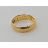 An 18ct gold wedding ring with Glasgow hallmarks for 1920, size L1/2, weight 4.4gms Condition