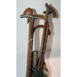 A silver mounted walking cane, other canes and parasols Condition Report: Available upon request