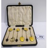 A cased set of six silver gilt and enamel coffee bean spoons Condition Report: Available upon