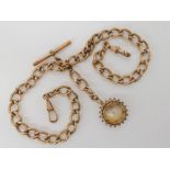 A rolled gold fob chain with a (af) 9ct gold compass fob Condition Report: Available upon request