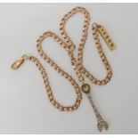 A 9ct gold curb chain necklace with a 9ct gold spanner and ingot pendants length 46cm, weight 23.
