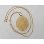 A 9ct gold engraved oval locket and chain, locket approx 4.5cm x 2.7cm including bail, chain