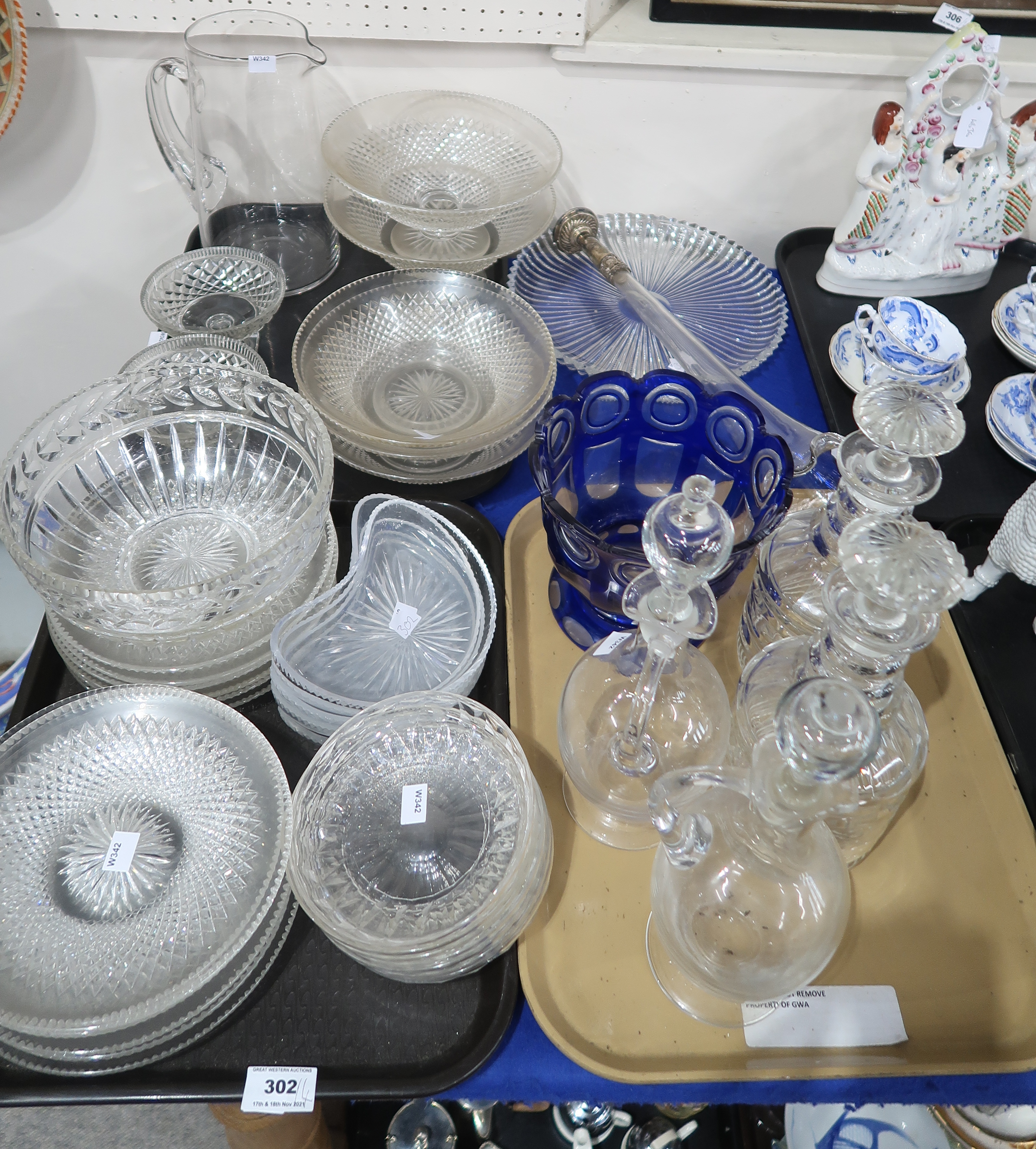 Assorted cut glass and crystal serving plates, bowls, a blue glass footed bowl, two triple ring neck