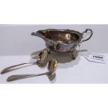 A lot comprising a silver sauce boat Birmingham 1966 with a pair of silver sauce ladles Birmingham