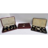 A lot comprising a cased 1937 George vi specimen coin set, a part set & an empty 1937 specimen