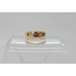 An 18ct gold red gem and diamond ring, size M1/2, weight 3.8gms Condition Report: Available upon