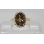 A 9ct gold smoky quartz and diamond ring size W, weight 4.4gms Condition Report: Available upon