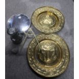 An EPNS circular tray, two chased brass chargers, one decorated with heraldic lions, the other