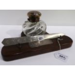 A matched silver topped inkwell, London 1895 on mahogany base with silver plaque inscribed "To