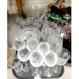 A selection of cut glass and crystal including a frosted glass pitcher with floral decoration, wheel