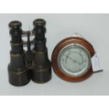 A pair of vintage binoculars and a small oak cased barometer, 12cm (2) Condition Report: Available