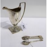 A lot comprising a silver helmet shaped cream jug, Sheffield 1909, 14 cm. high & four silver