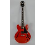 A cherry red Gibson ES335 semi-acoustic electric guitar serial number 11777712, this 2017 model