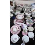 A collection of antique Staffordshire/Sunderland pink lustreware jugs, a teapot, bowls, cups and