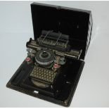 A Junior typewriter in original tin case Condition Report: Available upon request