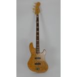 An rare Fender Jazz bass guitar in quilted maple, this deluxe Fender four string bass comes with a