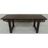 A CHINESE HARDWOOD ALTER TABLE the rectangular top above a scroll frieze on square legs joined by