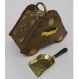 AN OAK PUGINESQUE COAL SKUTTLE AND SHOVEL fitted with hinged door and brass mounts, 37cm high,