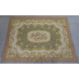 A WOVEN WOOL TAPESTRY decorated with a central floral cartouche and radiating foliage and scrolls,