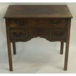 A GEORGE III MAHOGANY DRESSING TABLE with a long drawer above three short drawers and on square