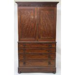 A VICTORIAN MAHOGANY LINEN PRESS with a pair of doors above four graduated drawers on ball feet,