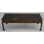 A CHINESE CARVED AND LAQUERED TABLE the top with figures in a garden amongst pavilions and before
