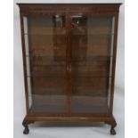 A VICTORIAN MAHOGANY DISPLAY CABINET ON STAND with ogee cornice above a pair of glazed doors and