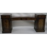 A 19TH CENTURY MAHOGANY TWIN PEDESTAL SIDEBOARD the concave centre set with two drawers above a pair