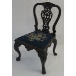 A CHIPPENDALE STYLE MAHOGANY DINING CHAIR the heavily carved pierced back decorated with foliate c