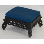 AN ANGLO INDIAN STYLE STAINED OAK FOOT STOOL the upholstered seat on a foliate carved frame and