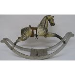 A VICTORIAN PAINTED ROCKING HORSE the traditional form on a scroll shaped base, 114cm high, 198cm