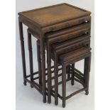 A CHINESE HARDWOOD NEST OF TABLES the recessed tops above carved geometric friezes and on slender